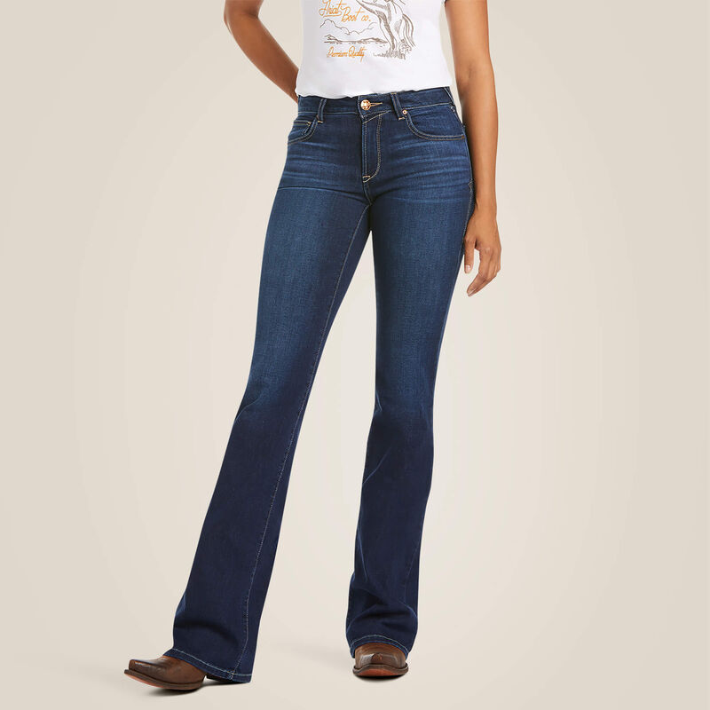 Person wearing blue jeans on a beige background