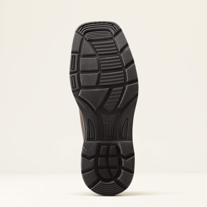 Close-up of a black shoe sole on a beige background