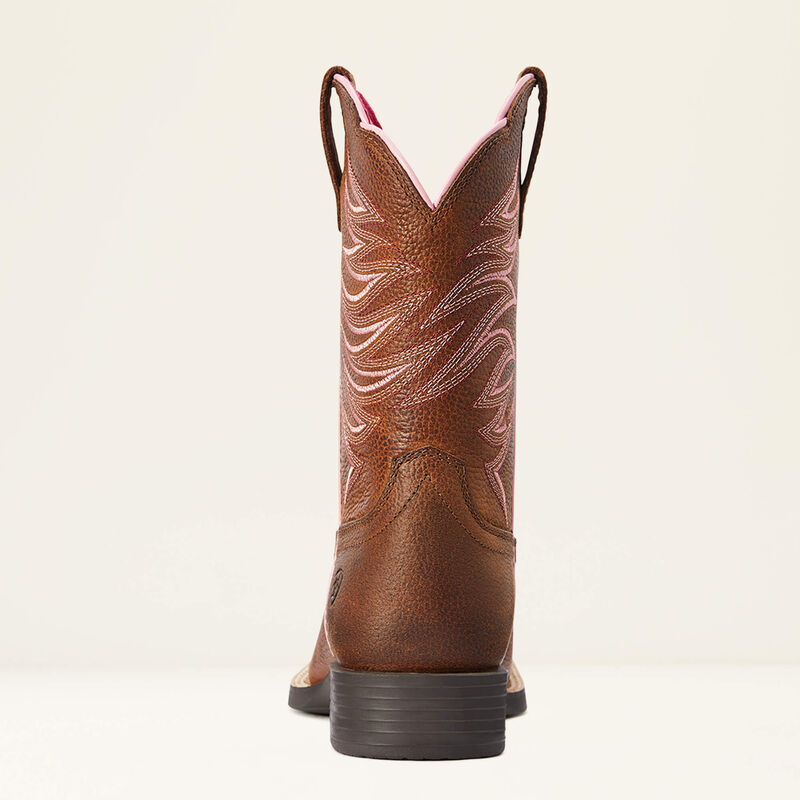 Brown cowboy boot with intricate design on a beige background