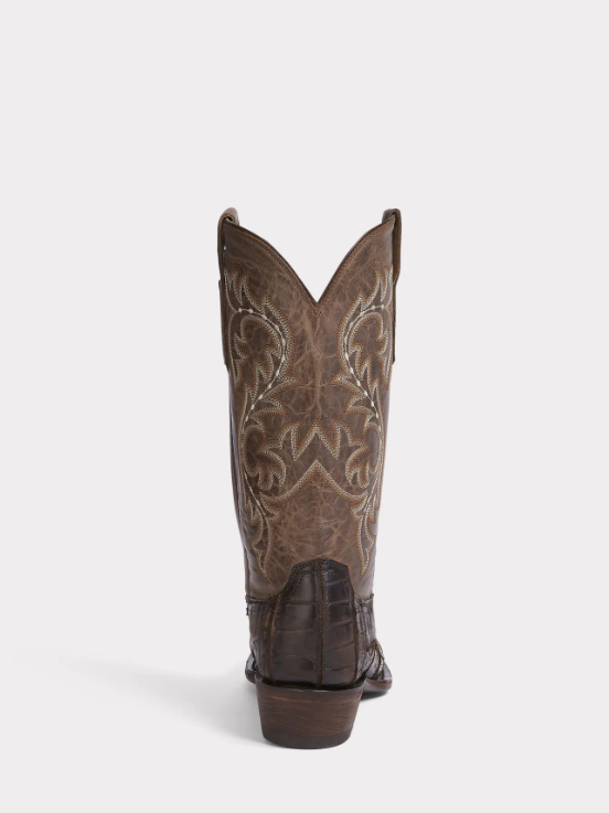 Brown cowboy boot with intricate embossing on a white background