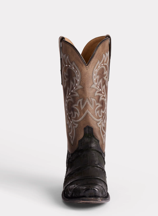 Brown cowboy boot with intricate design on a white background