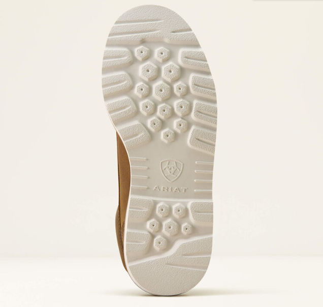 The outsole of a brown shoe, showing a textured white tread pattern and the embossed ARIAT brand logo, photographed against a light beige background.
