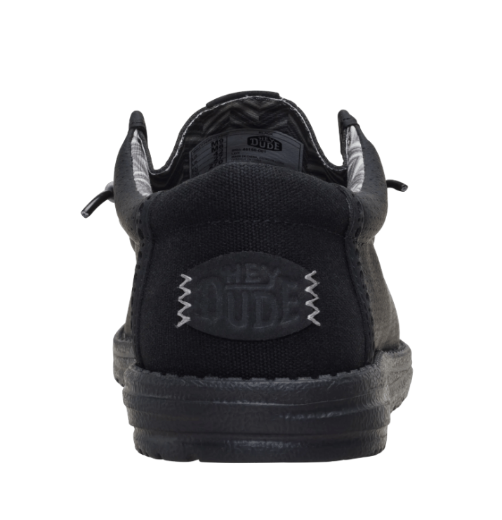 Black sneaker with 'Hey Dude' branding on a white background