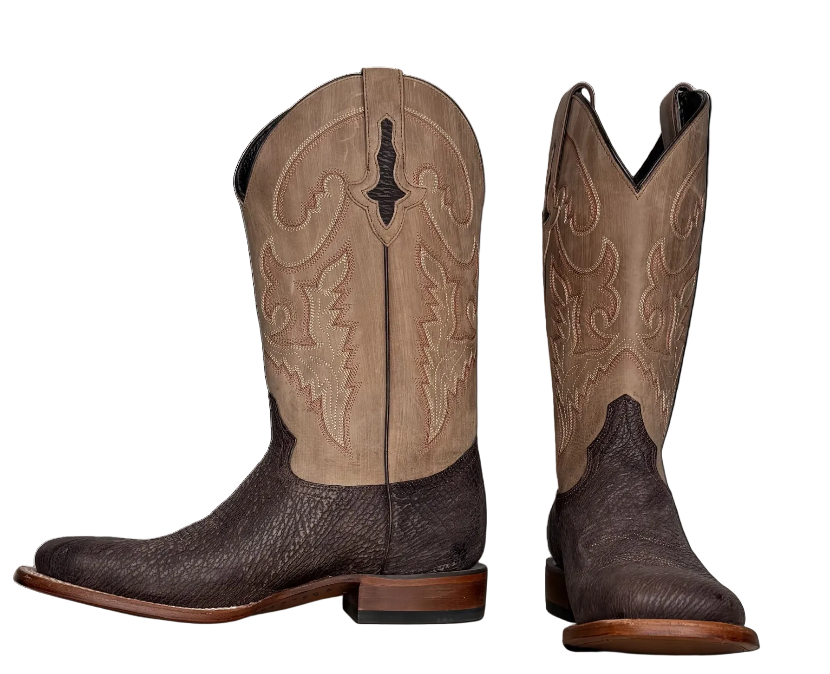Pair of brown cowboy boots with detailed design on a white background