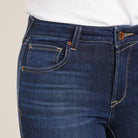 Close-up of blue jeans with a beige background