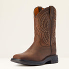 Brown leather boot with intricate stitching on a beige background