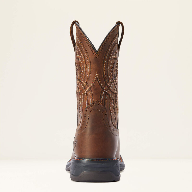 Brown cowboy boot with intricate design on a beige background