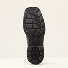 Close-up of a black shoe sole on a beige background