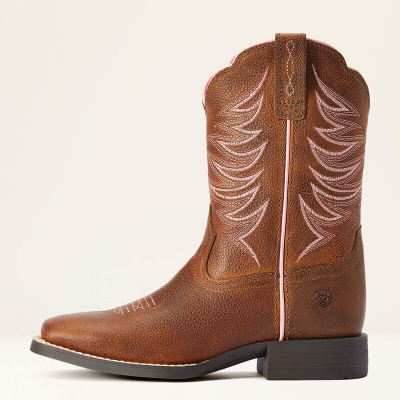 Brown cowboy boot with intricate stitching on a beige background