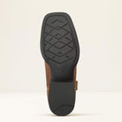 Close-up of a brown leather boot sole with black tread pattern on a beige background