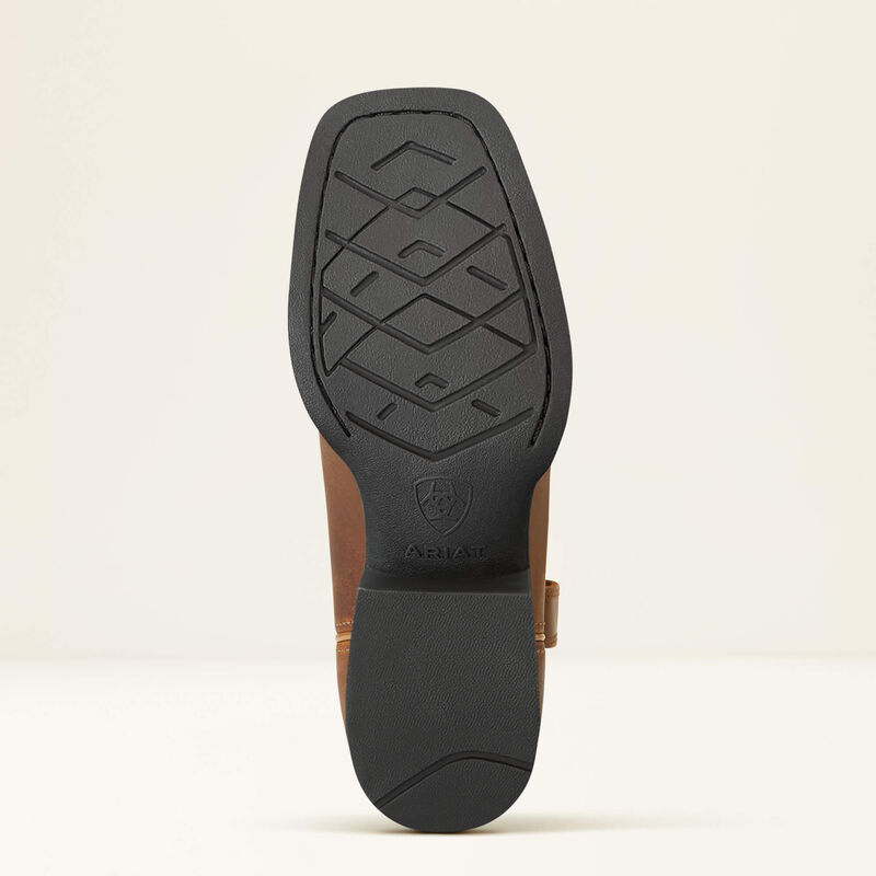 Close-up of a brown leather boot sole with black tread pattern on a beige background