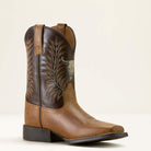 Brown cowboy boot with intricate embroidery on a beige background