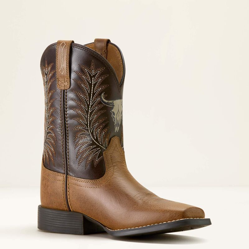 Brown cowboy boot with intricate embroidery on a beige background