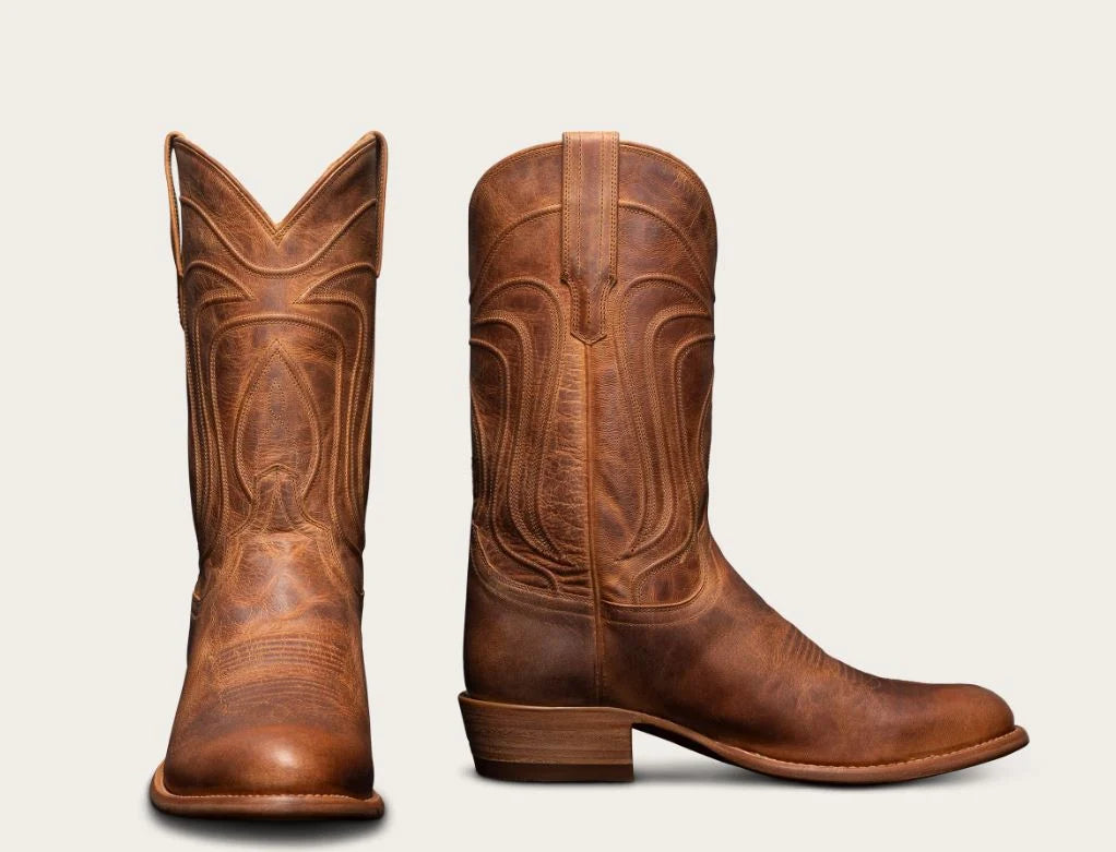 A pair of brown leather cowboy boots shown from the front and side against a light beige background.