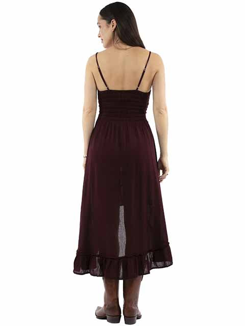 Woman wearing a burgundy dress with thin straps on a white background