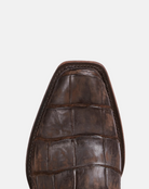 Brown leather shoe on a light gray background
