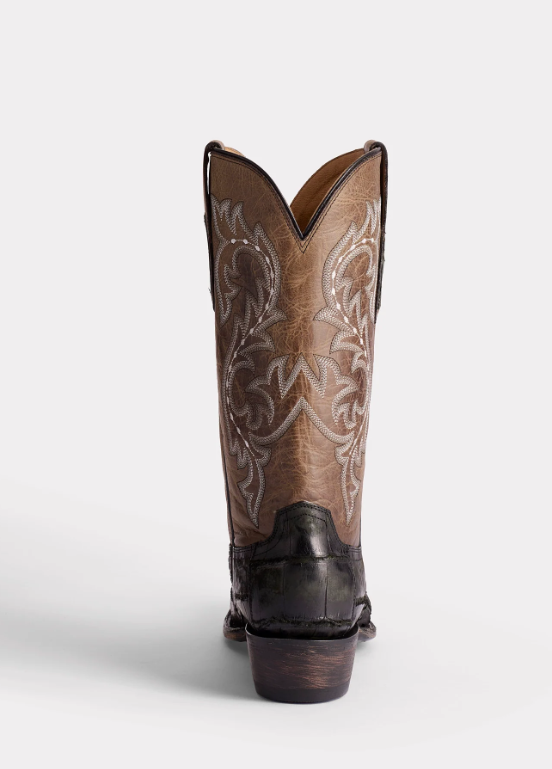 Brown cowboy boot with intricate white embroidery on a white background