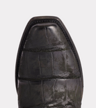 Close-up of a black leather shoe sole on a light gray background