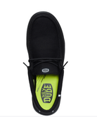 Black shoe with a bright green sole on a white background