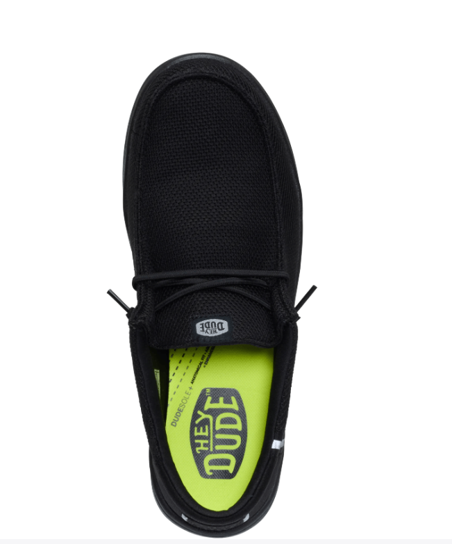 Black shoe with a bright green sole on a white background