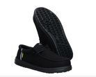 Black slip-on shoes with textured sole on a white background