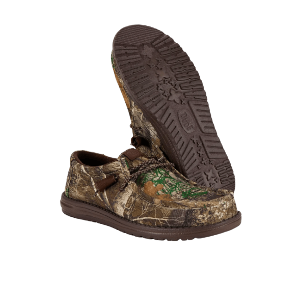 Camouflage shoe with brown laces and sole on a white background