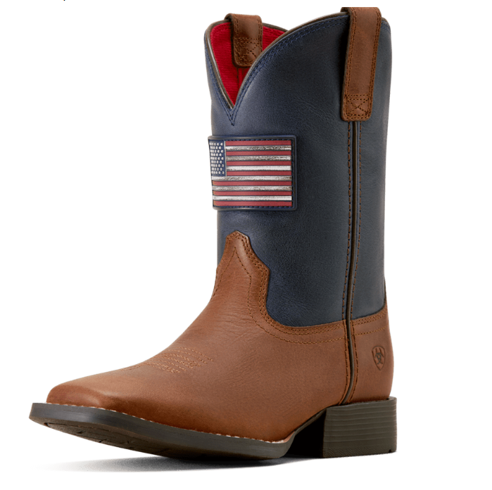 A single western boot shown in profile on a white background. The boot has a dark navy blue shaft, a tan leather foot, and a small American flag patch on the side.
