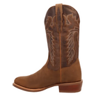 A brown leather cowboy boot with decorative western stitching on the shaft, shown in side profile against a dark blue background. A Dan Post logo is visible in the bottom-left corner.