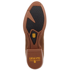 Top-down view of a brown leather boot sole with a black textured tread pattern and a gold Dan Post logo, set against a dark blue background.