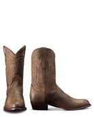 Pair of brown cowboy boots on a white background