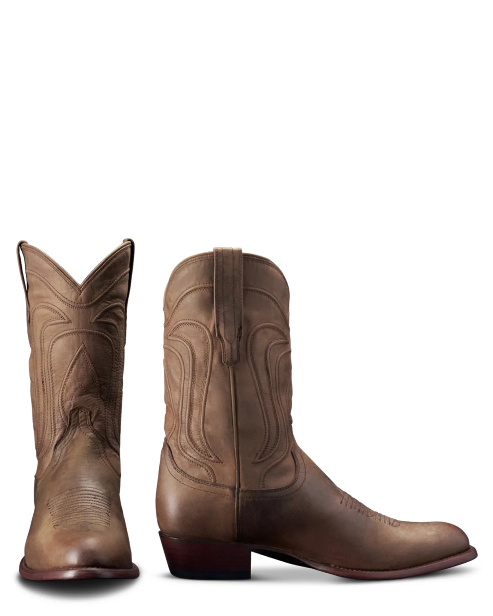 Pair of brown cowboy boots on a white background