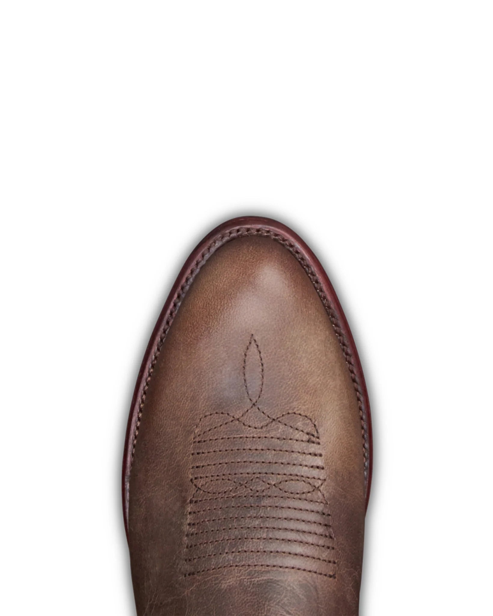 A close-up top-down view of a brown leather boot toe showing the pointed vamp, decorative stitching, and a dark red edge along the upper.