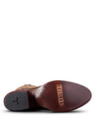 Close-up of a brown leather boot sole with 'Tecovas' branding on a white background